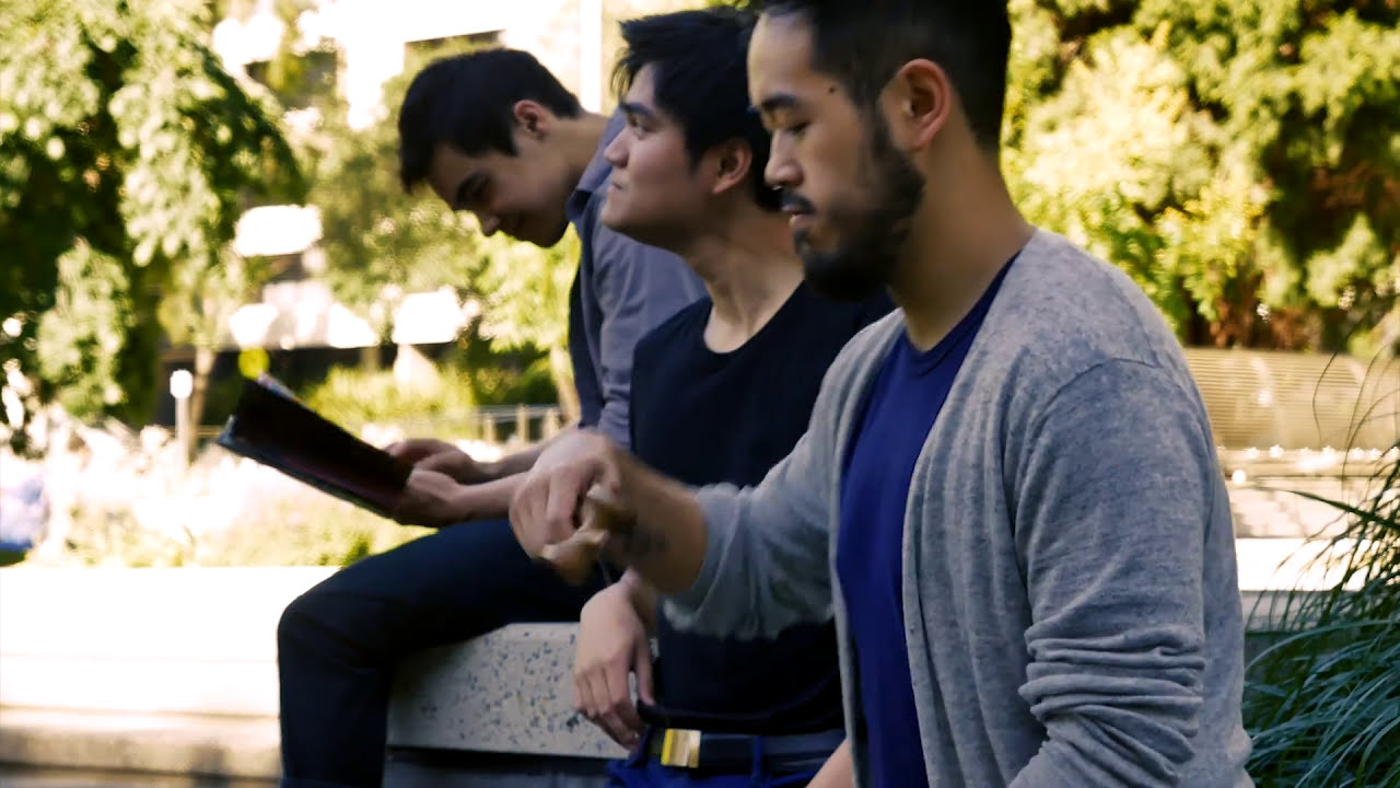 Jericho and two collaborators sitting outside in a still from Gangsta
